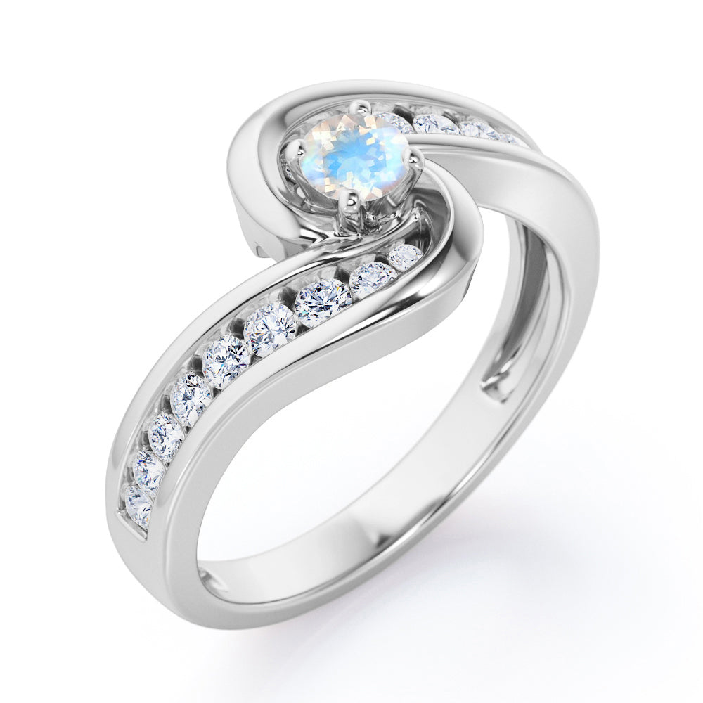 Spinning 0.7 carat Round Moonstone and Moissanite Channel Engagement Ring in Rose Gold